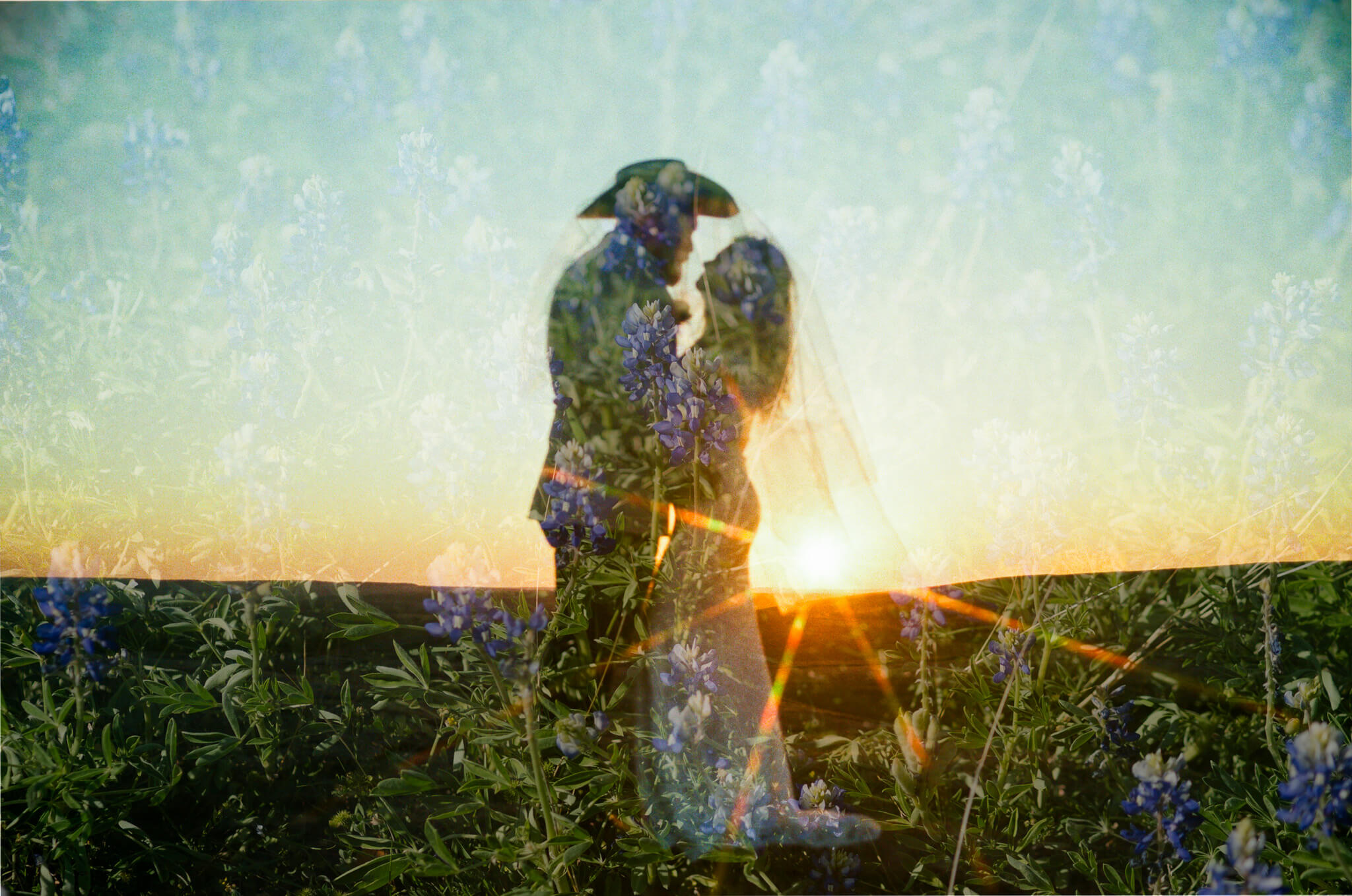 film double exposure of blue bonnets over a couple at the summit of enchanted rock, one of the best places to elope in texas