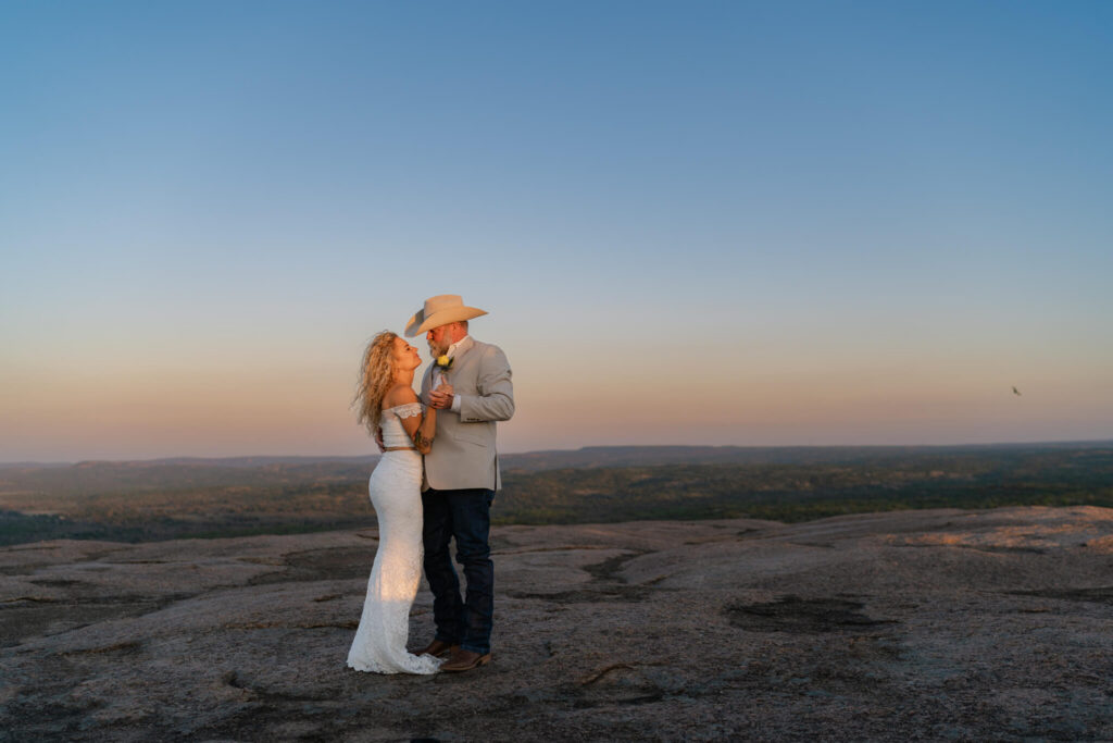 couple sharing a private first dance on top of Enchanted Rock, one of the best places to elope in Texas