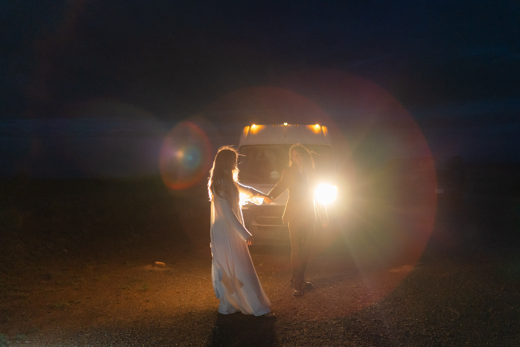 Couple dancing in the headlights after elopement