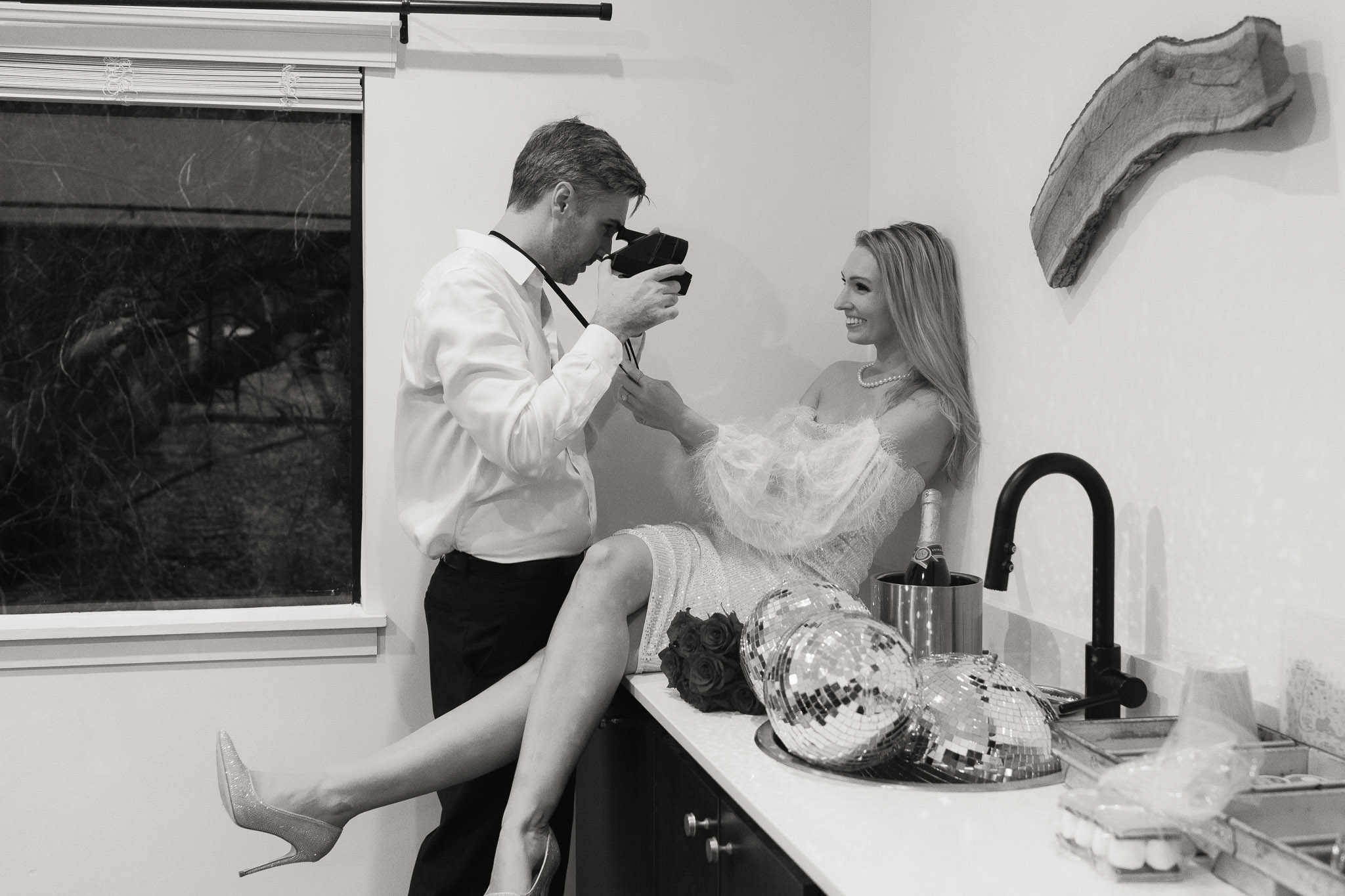 couple has fun taking photos of each other on a vintage polaroid camera