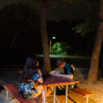 Bride and Groom share a quiet moment at the campsite under the darkness of night before getting ready for their Enchanted Rock Elopement