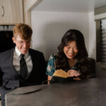 couple cozy's up together in the Bride writes her vows in the cozy camper ambient lighting