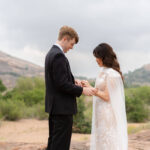 Bride and groom exchange their wedding bands on a secluded trail during their Enchanted Rock Elopement