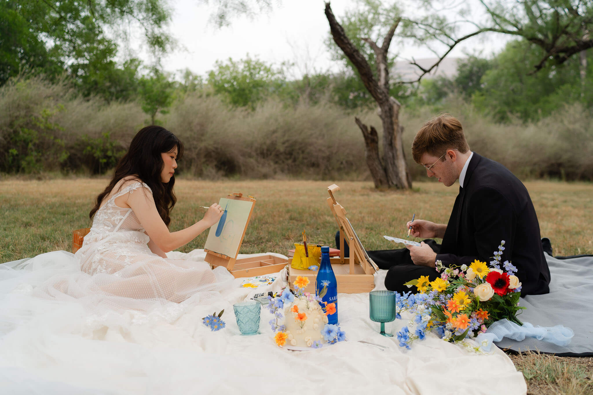 Picnic setup with cake and flowers at Enchanted Rock elopement campsite