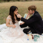 bride and groom share a fun moment together after unique cake cutting with cups
