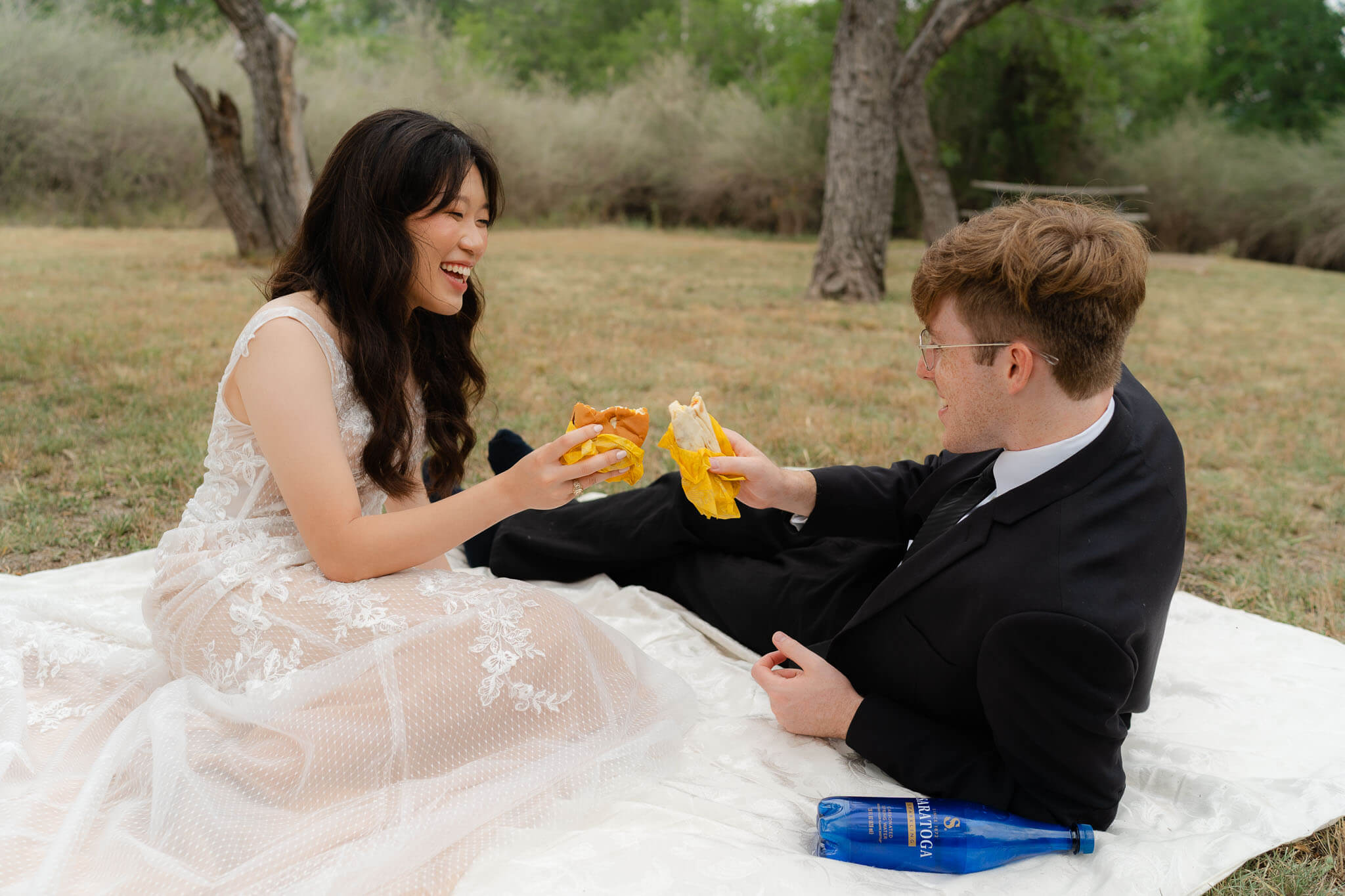 bride and groom sharing whataburger during their creative and relaxing enchanted rock elopement