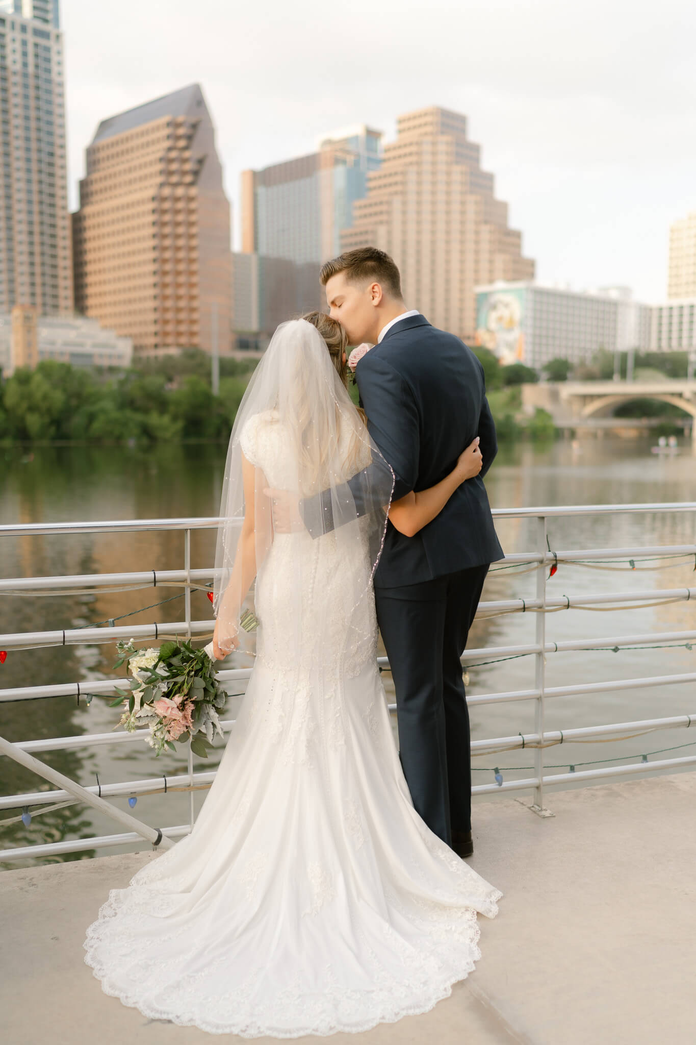 Couple standing on the deck of a Austin river boat after their Austin elopement