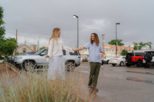 couple laughs and enjoys rainy afternoon before dead horse point wedding in moab