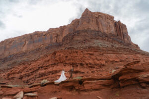 Portrait of couple exploring red rock face trail