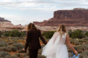 couple walks to secluded ceremony location