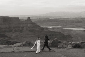 couple runs around dead horse point in blue hour light