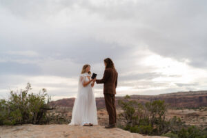 bride shares vows to her groom during secluded dead horse point wedding