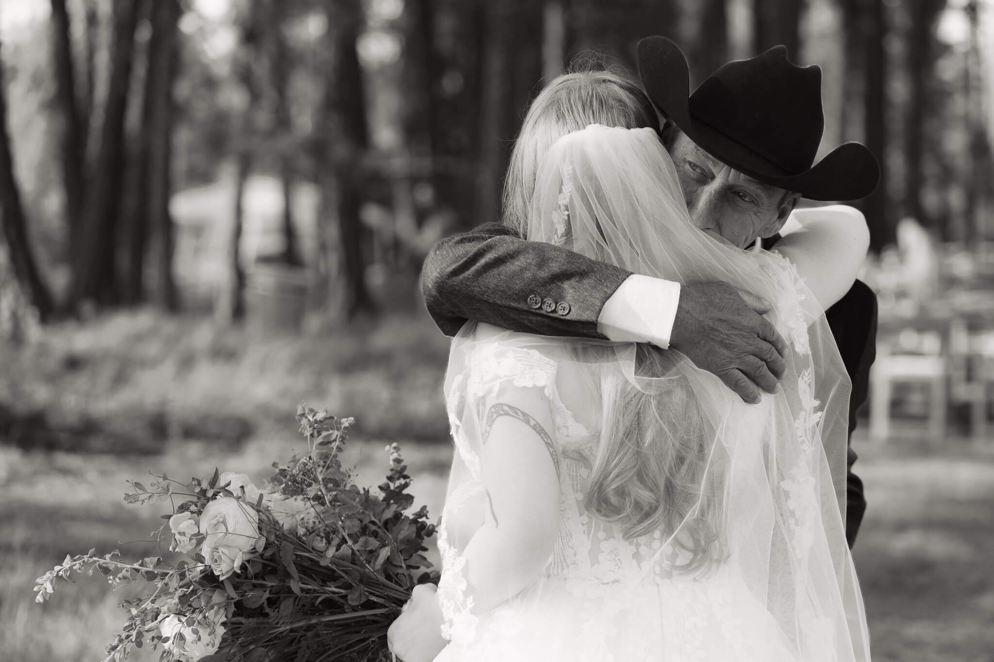 Heartfelt father daughter moment captured during intimate Bigfork wedding by Kalispell Wedding Photographer