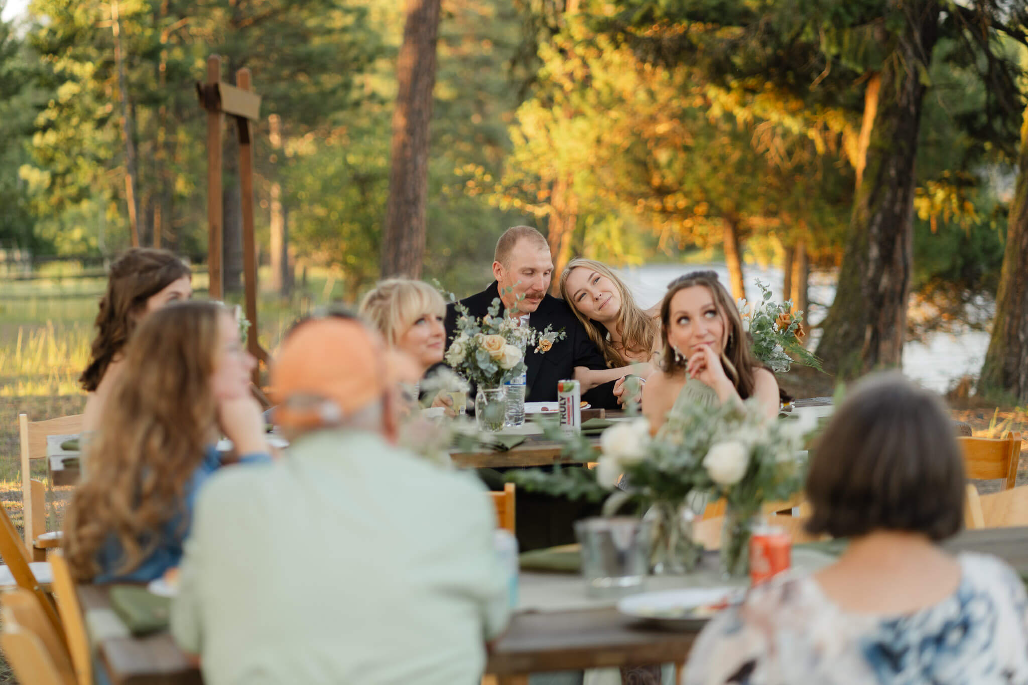 Heartfelt moment between bride and groom during toasts captured during intimate Bigfork wedding by Kalispell Wedding Photographer