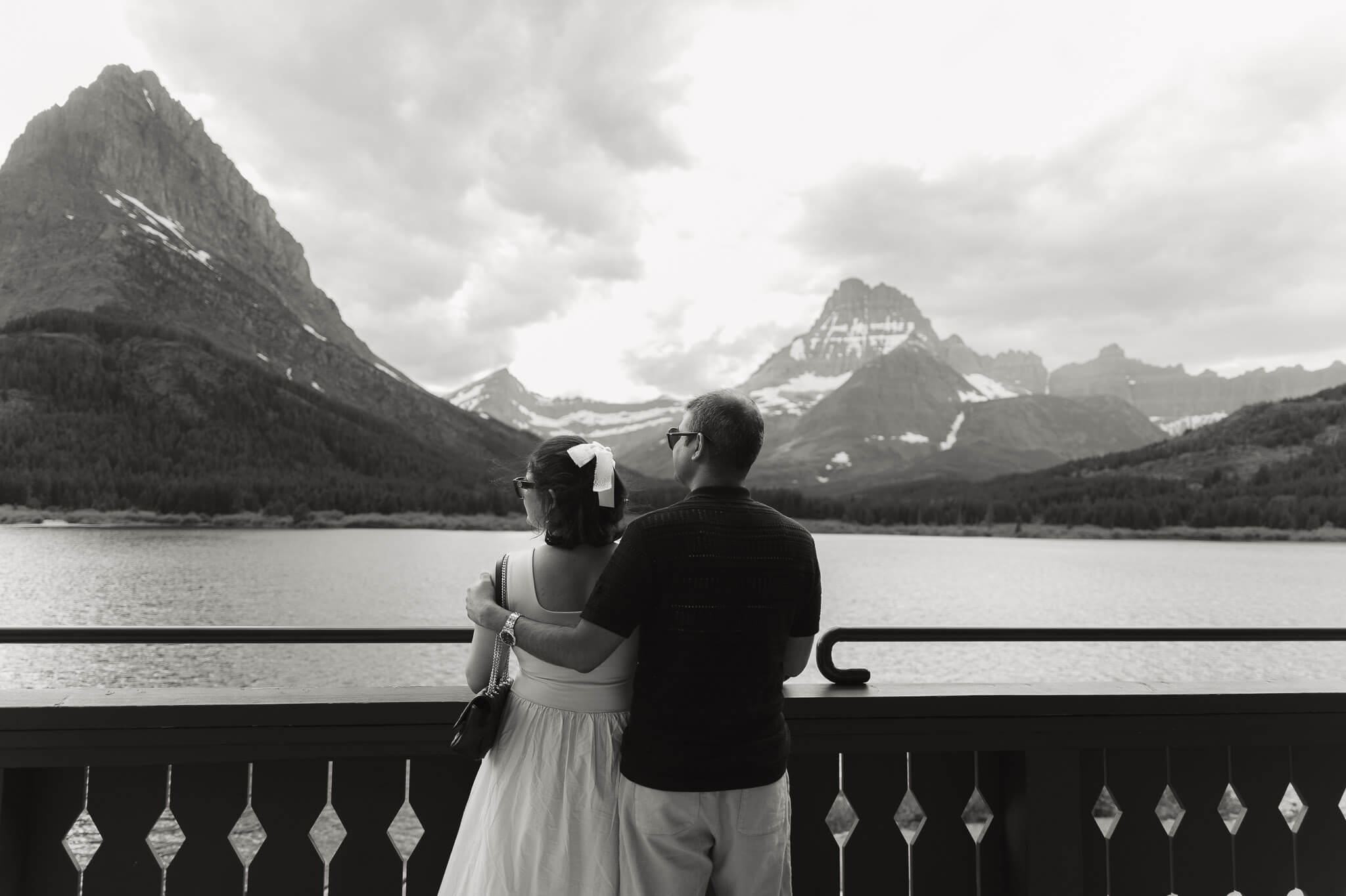Couple overlooking Glacier lake in Many Glacier a beautiful places to elope in Montana