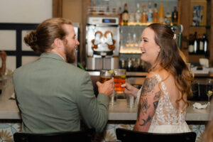 Couple shares a drink together before heading up to their Post Elopement Party