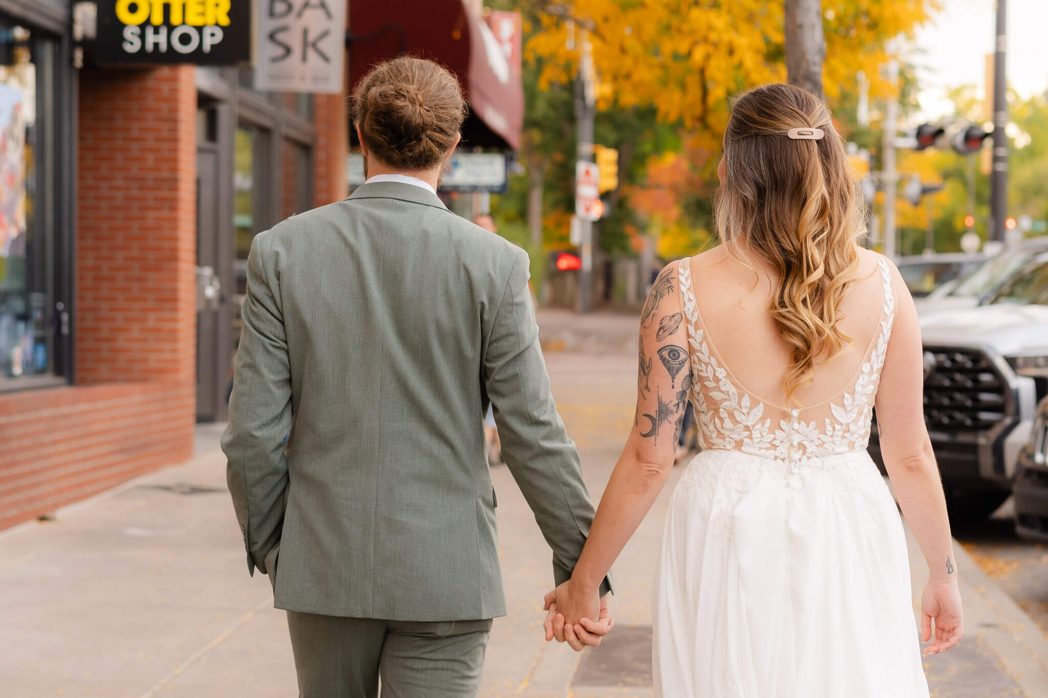 couple walking to their downtown venue for their elopement party