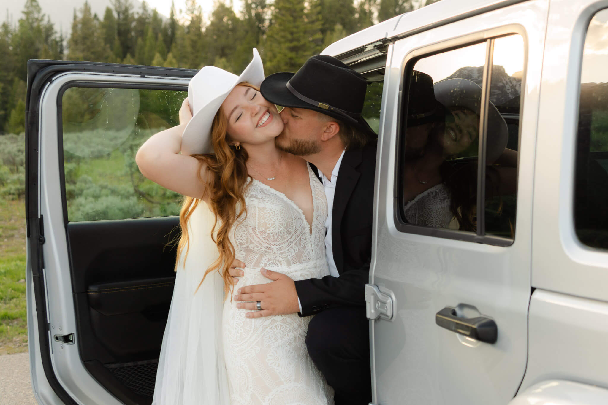 Couple laughing at their jeep after 4x4 San Juan Mountains elopements