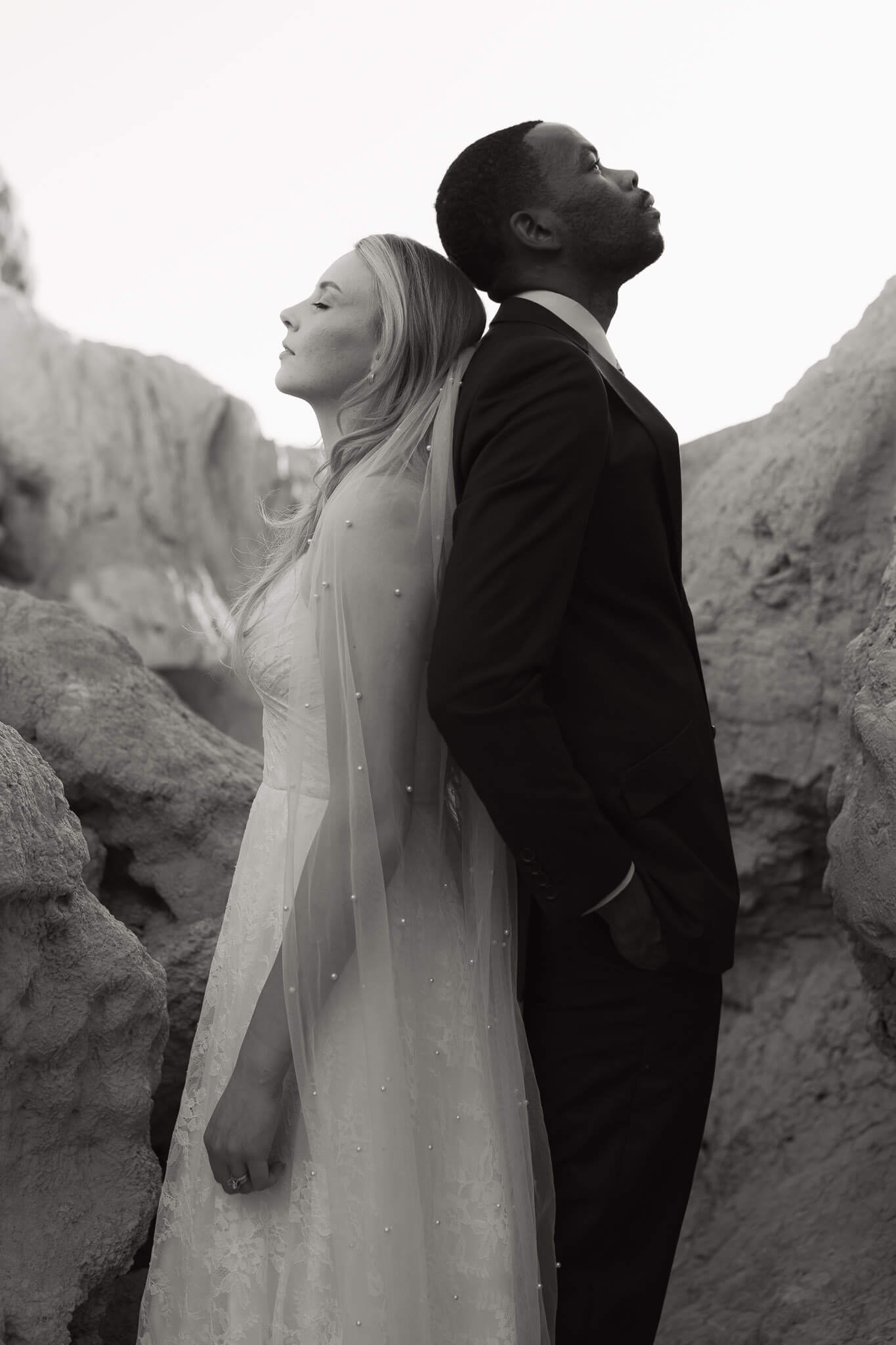 couple stands back to back - inspiration to elope in colorado springs