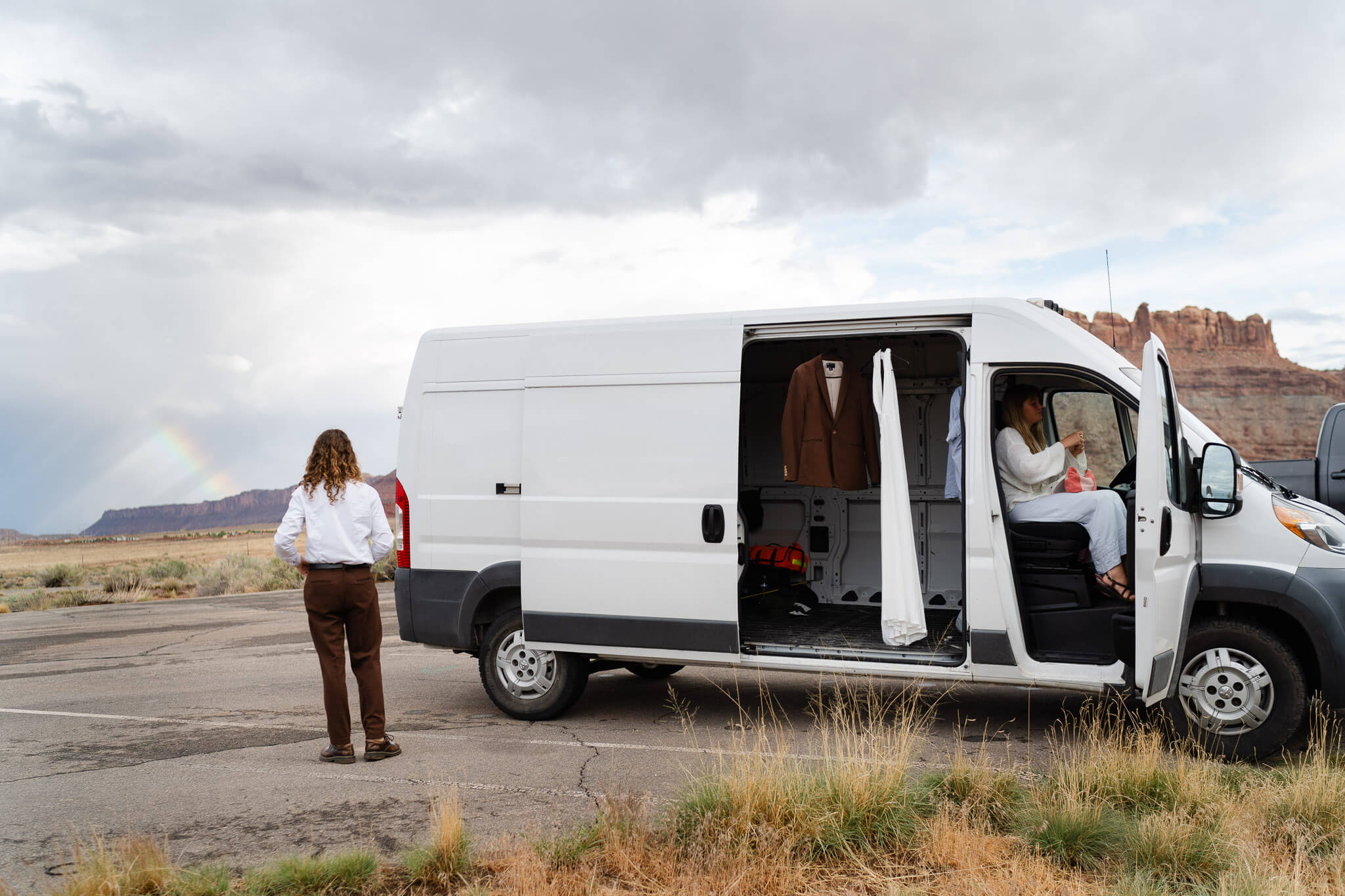 Couple getting ready at their van, before they elope in Utah.