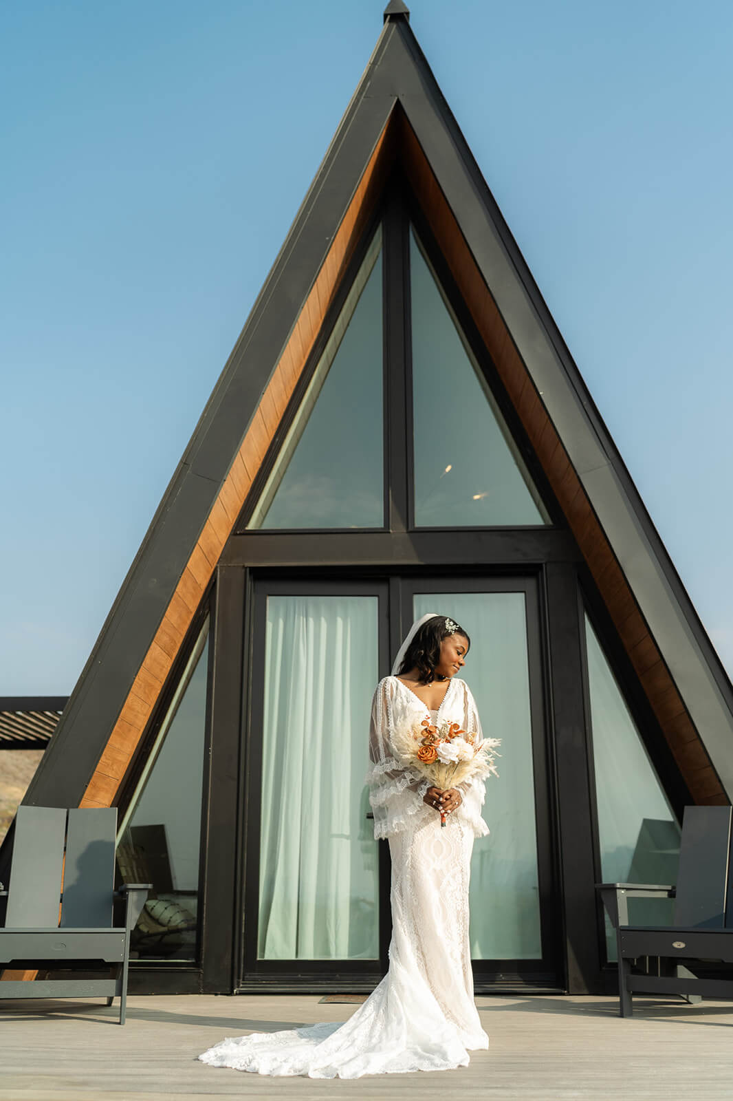 Bride in front of her A frame rental before her elopement, while this photo wasn't from a Utah elopement, it does show you why your getting ready space can help create the vibe of your day