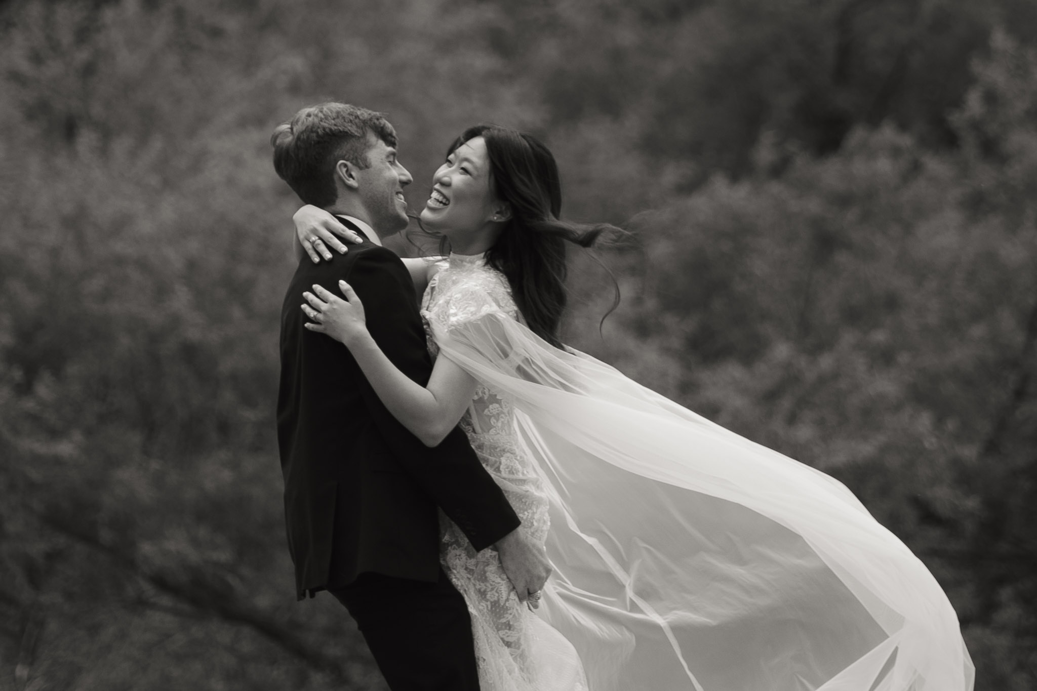 groom picks up his wife after their ceremony