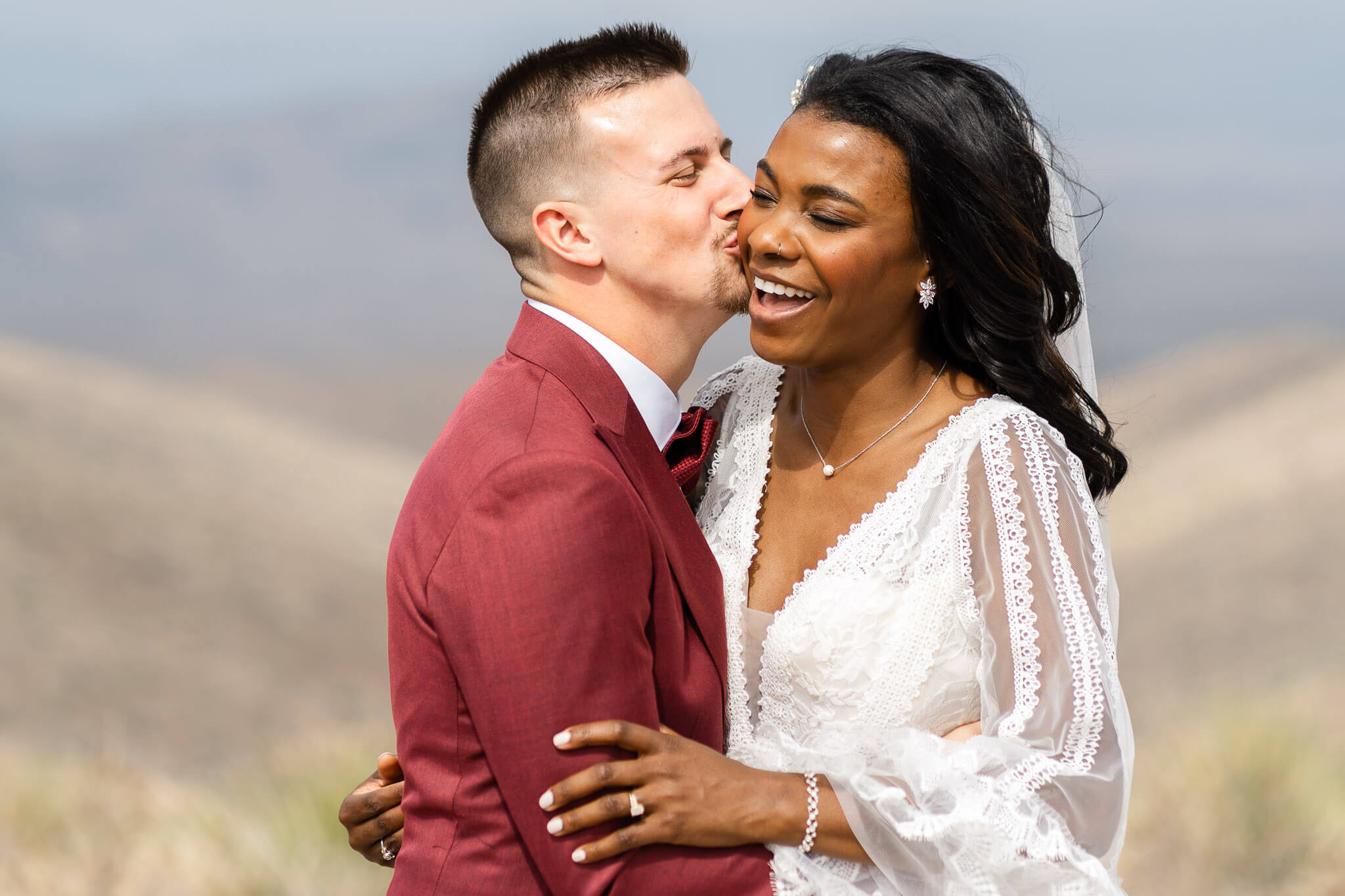 Groom kisses his brides cheek after their Great Sand Dunes National Park Elopement