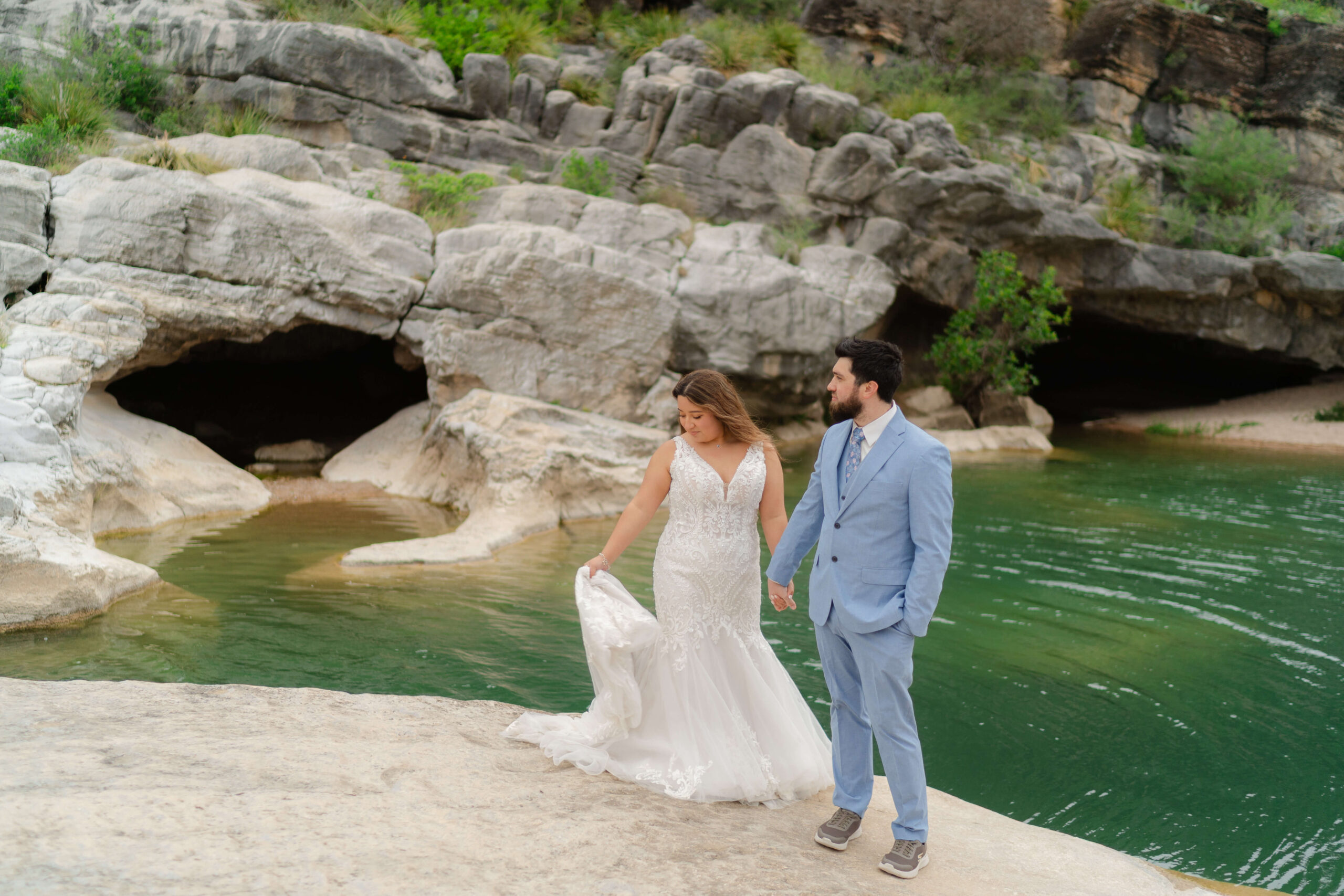 Couple sharing a quiet moment at the blue pools of Pedernales Falls