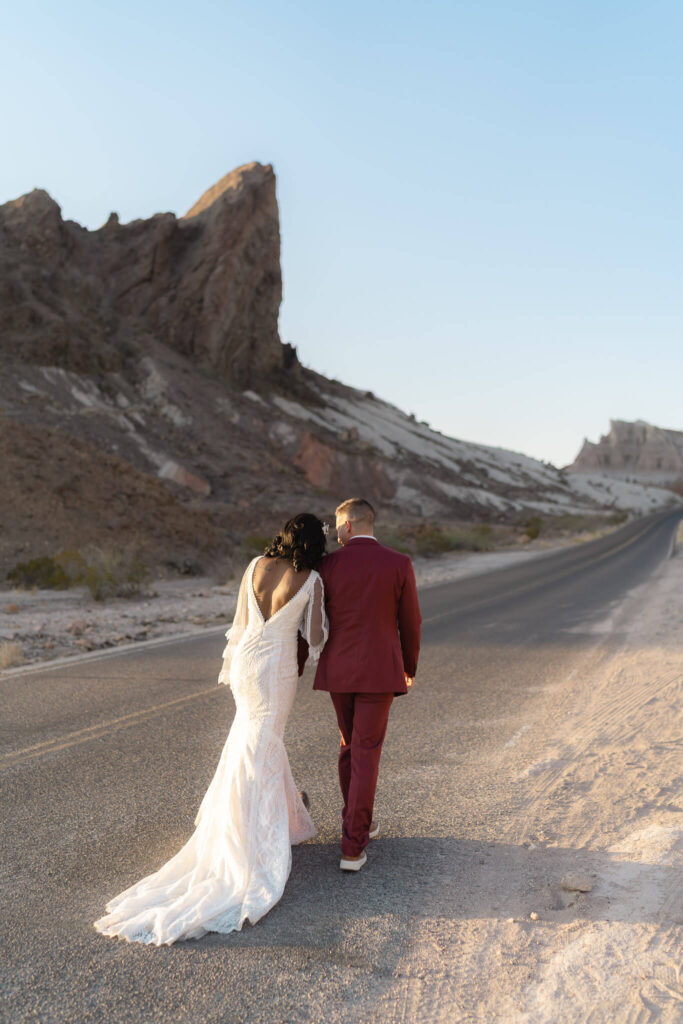 bride and groom walking along the road after they elope in texas