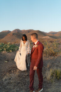 bride walking towards groom at sunset