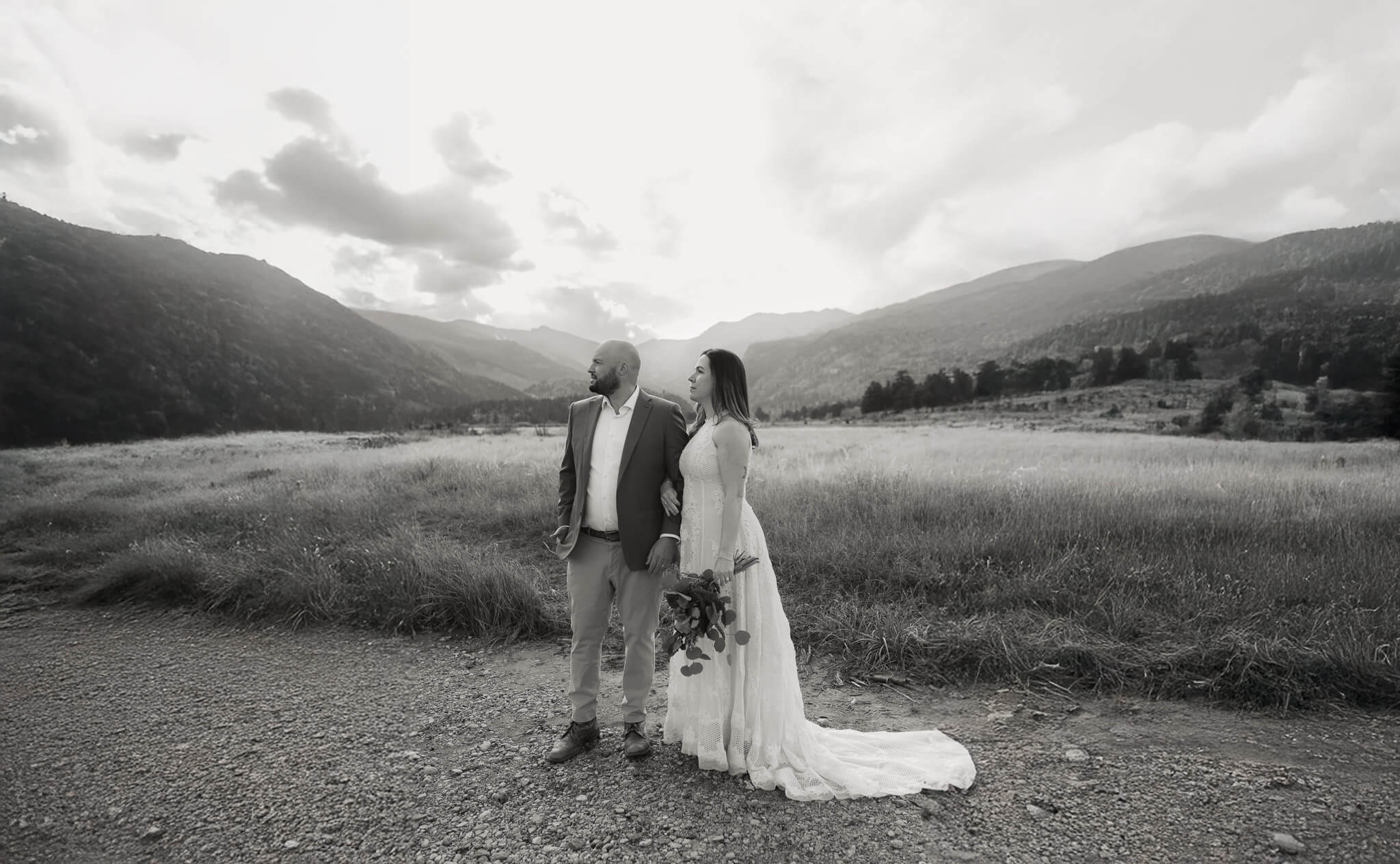 Couple standing together looking off to the mountains after their Twin lakes elopement