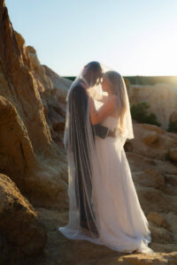 the afternoon sunlight streams through a brides veil after she and her husband elope in Colorado