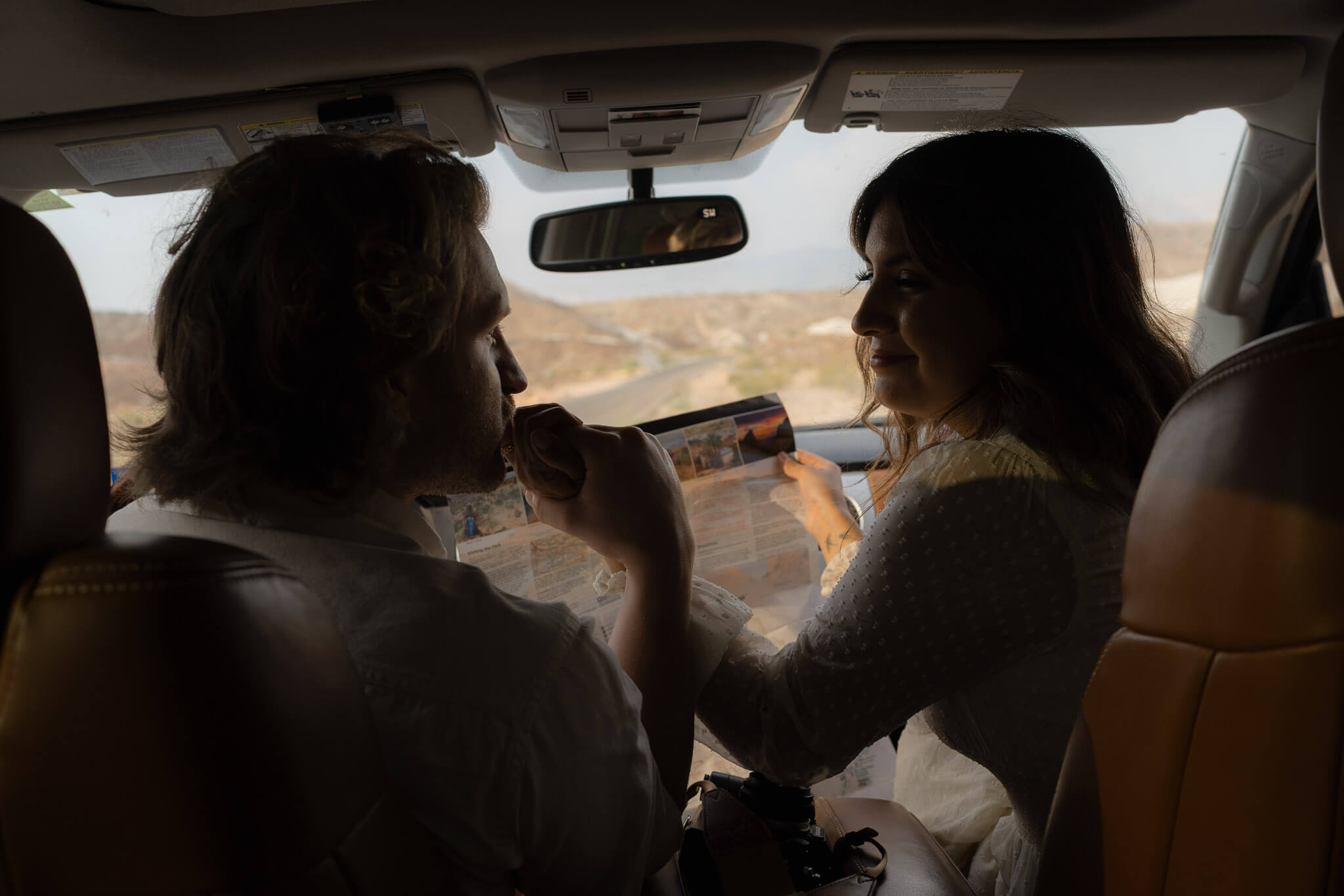 elopement timeline isporation guide: couple sharing a quiet moment in their vehicle before heading out for their elopement