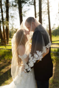 couple under the veil in the forest