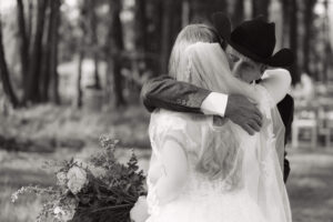 dad hugs his daughter before her ceremony