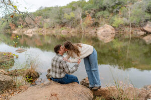 couple overlooking a lake at their Hill Country Engagement photos