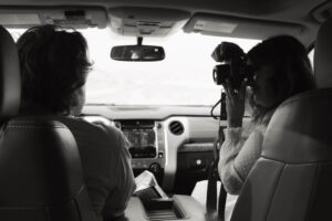 couple in the front seat of a vehicle during their roadtrip themed texas engagement photos in Big Bend