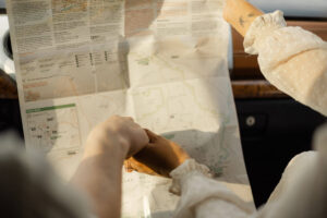 couple holding hands and looking at a map during their Big bend engagement photos