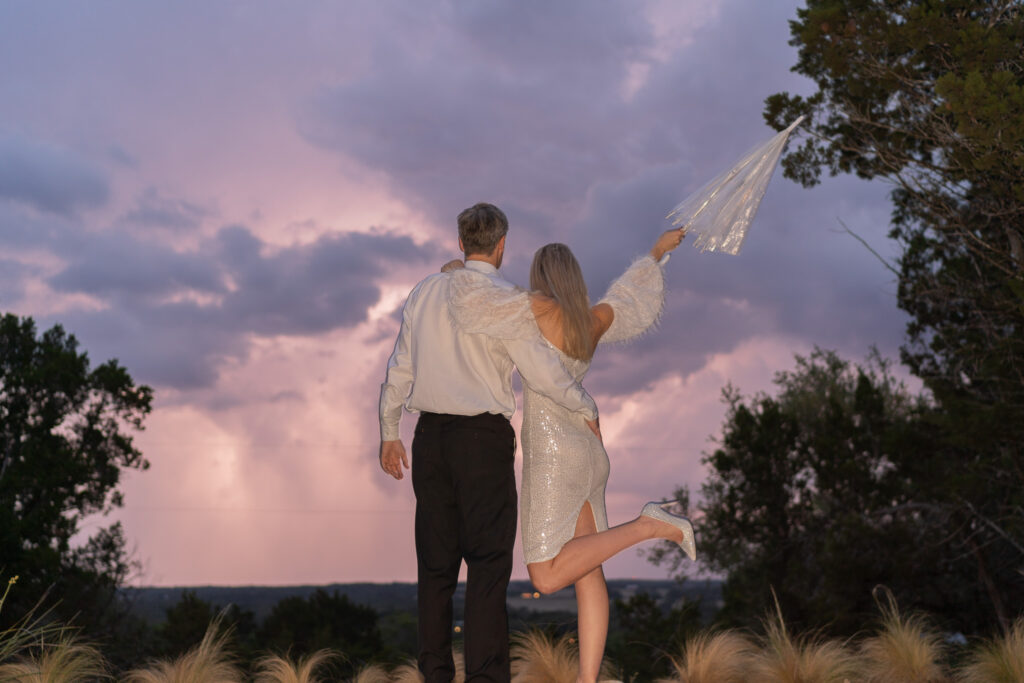 Couple Celebrating their elopement in the Texas hill country at Lucky Arrow Retreat in Dripping Springs as a thunderstorm rolls in